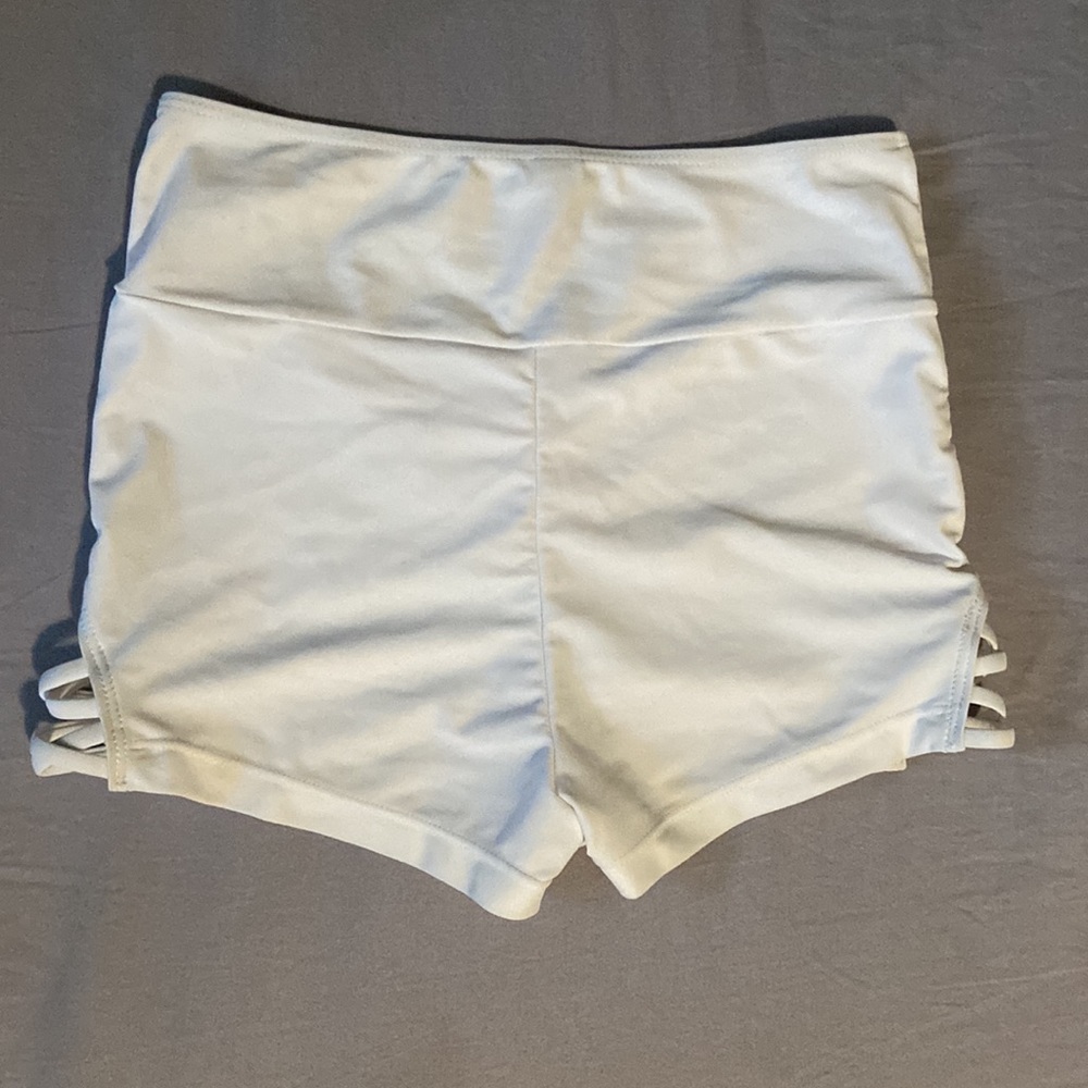 Simple white swimming shorts with cute detail on each side